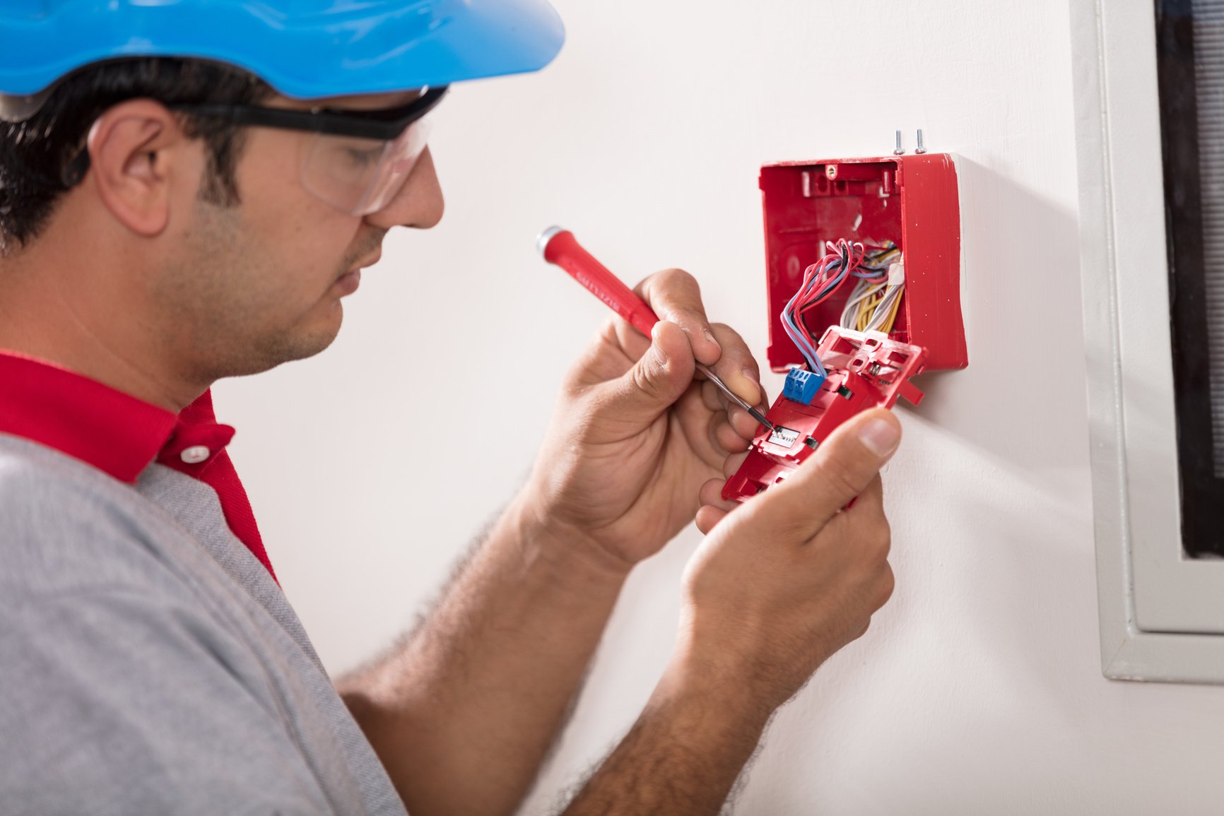 Man installing fire alarm